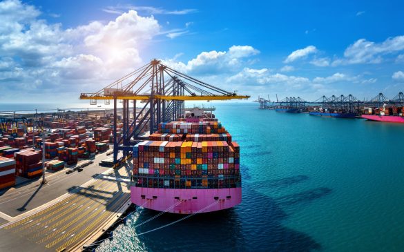 Aerial view of cargo ship and cargo container in harbor.